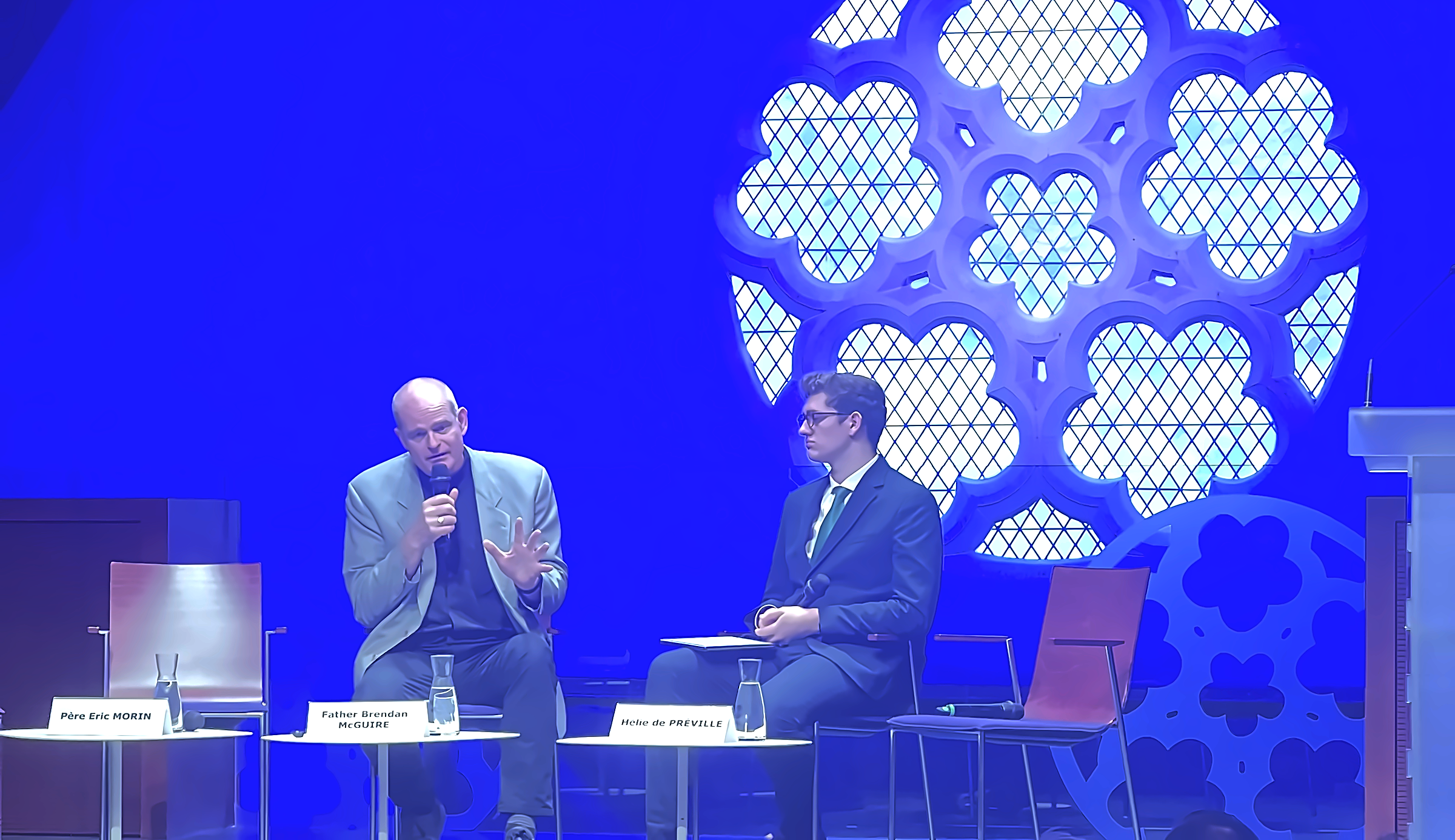 Father Brendan McGuire and Hélie de Préville on stage beneath the rose window of the Grand Auditorium, Collège des Bernardins, during the conference on Magnifica humanitas, the first encyclical on AI